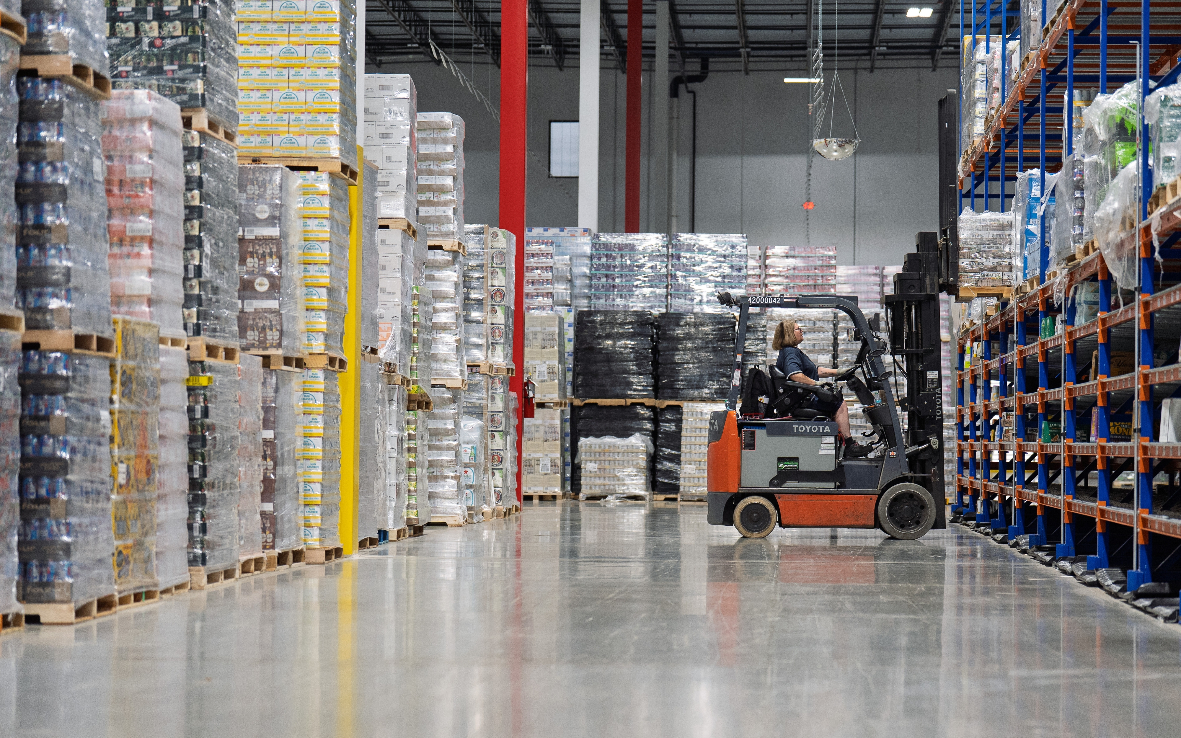 employee on a forklift in a warehouse